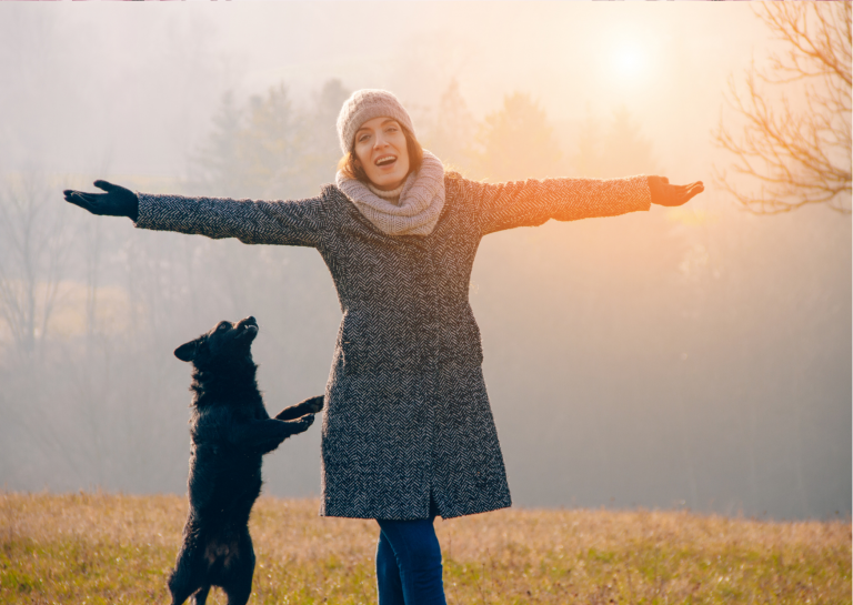 Happy woman with her dog jumping relaxed and confident