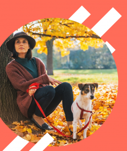 relaxed woman sitting with her calm dog in Nature